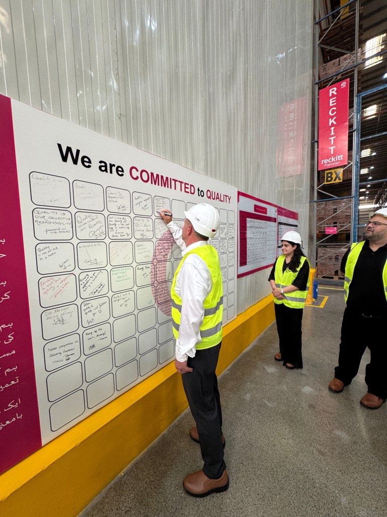 Reckitt Chief Supply Officer signing the quality commitment wall at the Connect Logistics distribution centre